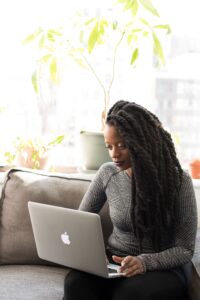 A black woman on a laptop